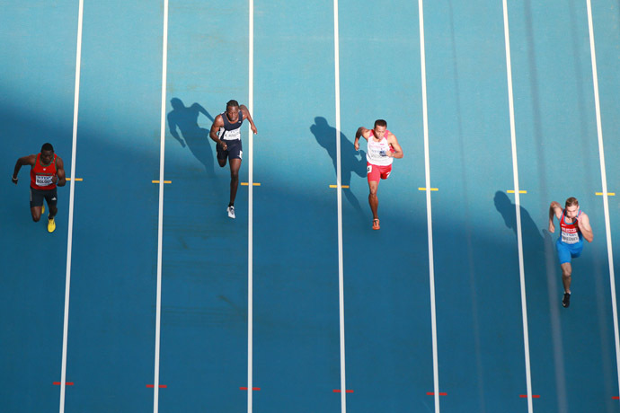 Russia's sprinter Aleksandr Bredvnev (right) passes 100 meters qualification run at the World Athletic Championship in Moscow. (RIA Novosti/Anton Denisov)