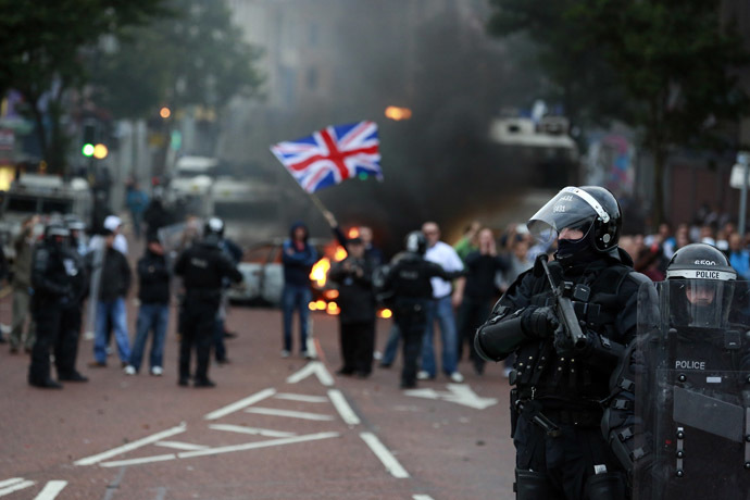 Police officers patrol the streets after loyalist protesters attacked the police with bricks and bottles as they waited for a republican parade to make its way through Belfast City Centre, August 9, 2013. (Reuters/Cathal McNaughton)