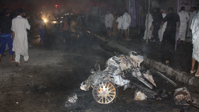 People gather at the site of a car bomb attack in Nasiriyah city, 375 km (233 miles) south of Baghdad, August 10, 2013. (Reuters / Stringer)