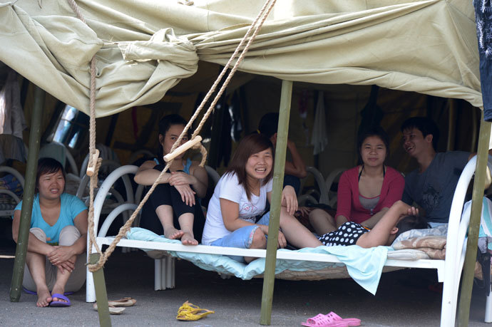Residents of a tent camp for migrants in Moscow's Golyanovo district.(RIA Novosti / Evgeny Biyatov)
