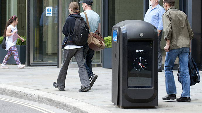People walk past a "pod" high-tech trash bin in the City of London (AFP Photo / Mona Boshnaq)