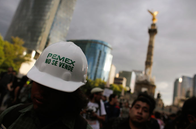 A demonstrator wears a helmet with a sticker that reads "Pemex is not for sale" during a protest against the privatization of the state oil monopoly Pemex in Mexico City July 1, 2013.(Reuters / Tomas Bravo)