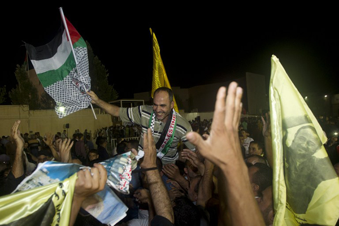 Palestinians prisoners released by Israel are greeted by relatives at the Palestinian President's headquarters in the West Bank city of Ramallah, August 14, 2013. (AFP Photo / Ahmad Gharabli)