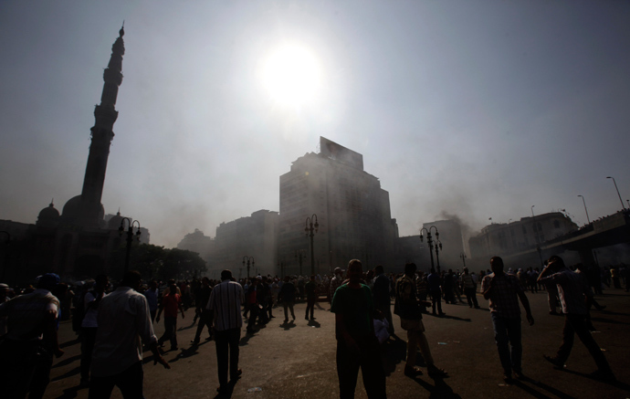 Smoke rises over Ramses Square as members of the Muslim Brotherhood and supporters of ousted Egyptian President Mohamed Mursi protest in front of Azbkya police station in Cairo, August 16, 2013 (Reuters / Amr Abdallah Dalsh)