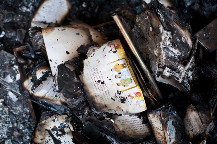 A picture taken on August 18, 2013 shows burnt books in the Amir Tadros coptic Church in Minya, some 250 kms south of Cairo, which was set ablaze on August 14, 2013. (AFP Photo/Virginie Nguyen Hoang)