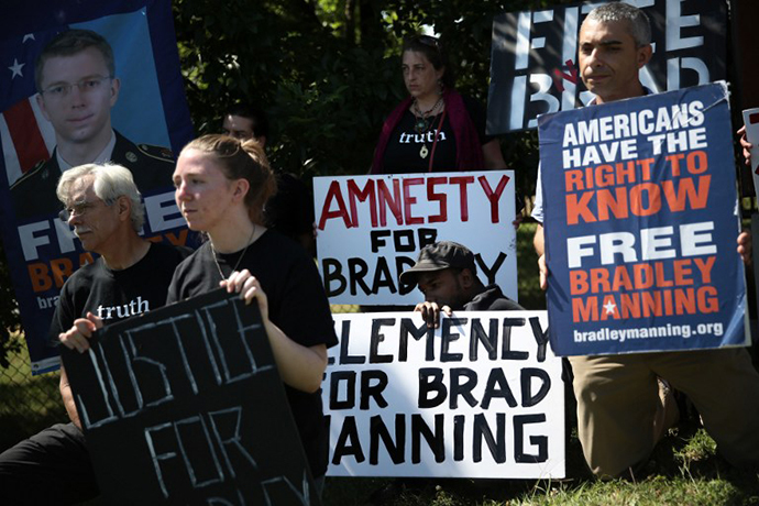 Supporters of U.S. Army Pfc. Bradley E. Manning hold signs to show support during a demonstration outside the main gate of Ft. Meade July 30, 2013 in Maryland. (AFP Photo / Alex Wong)