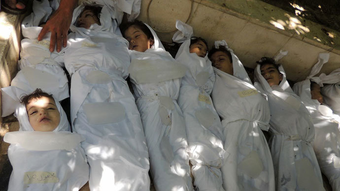 A handout image released by the Syrian opposition's Shaam News Network shows bodies of children wrapped in shrouds laid out on the ground as Syrian rebels claim they were killed in a toxic gas attack by pro-government forces in eastern Ghouta, on the outskirts of Damascus on August 21, 2013.(AFP Photo / Daya Al-Deen)