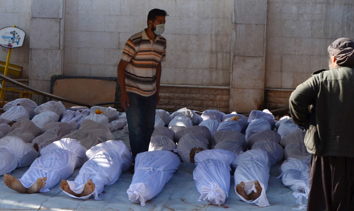 Syrian activists inspect the bodies of people they say were killed by nerve gas in the Ghouta region, in the Duma neighbourhood of Damascus August 21, 2013. (Reuters/Bassam Khabieh)