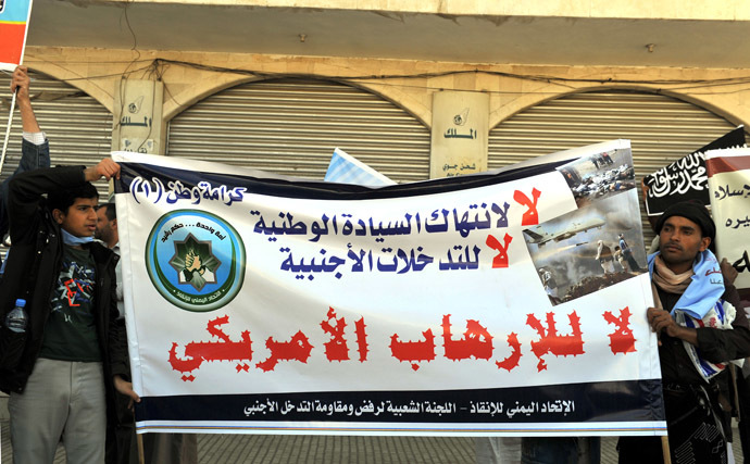 Yemenis hold up a sign in Arabic that reads, "No to Foreign Intervention...No to American Terrorism" during a protest against US drone attacks on Yemen close to the home of Yemeni President Abdrabuh Mansur Hadi, in the capital Sanaa, on January 28, 2013. (AFP Photo)