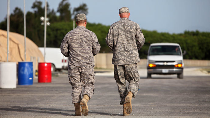 In this photo, reviewed by the US military, US troopers walk on the grounds of the Camp Justice compound, the site of the US war crimes tribunal, at Guantanamo Bay US Naval Base, Cuba, Thursday, July 16, 2009.(AFP Photo / Brennan Linsley)