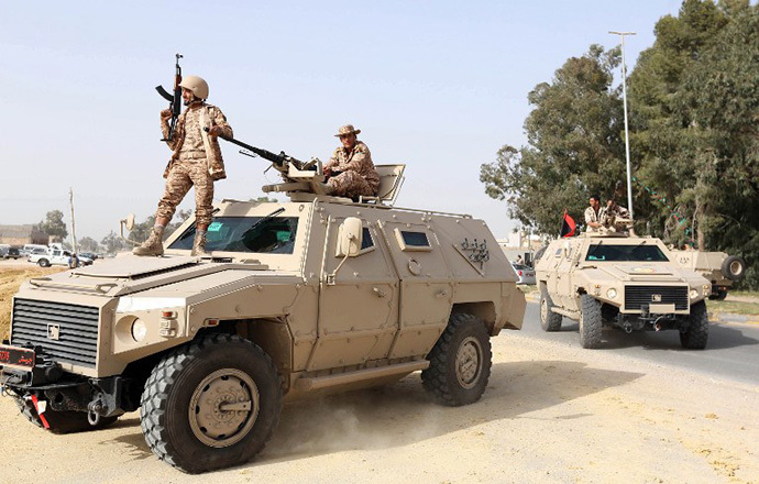 Joint Libyan forces from the ministries of defence and interior, raid bases of illegal militias made up of former rebels who did not join the army or internal security forces, in the capital Tripoli on March 18, 2013. (AFP Photo / Mahmud Turkia)