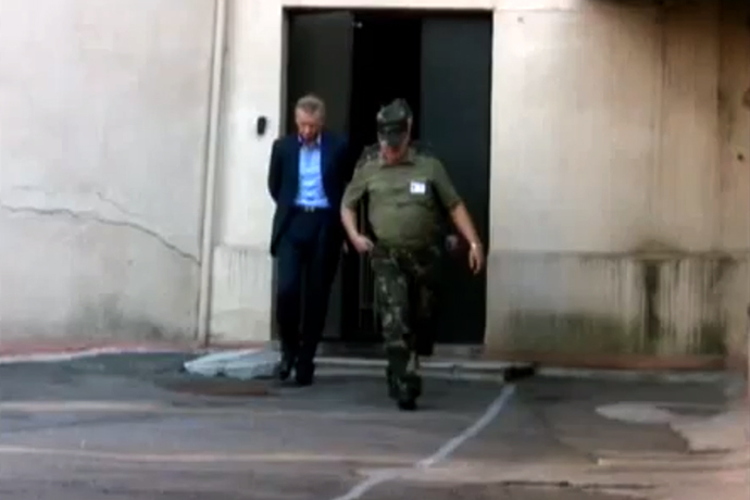 Vladislav Baumgertner handcuffed and led into a holding cell, as shown by Belorusian state TV chanel 'Novosti'. Taken from a video by ONT TV channel.