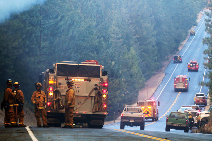 Fire crews line up along Highway 120 at the Rim Fire in this undated United States Forest Service handout photo near Yosemite National Park, California, released to Reuters August 27, 2013. (Reuters/Mike McMillan/U.S. Forest Service/Handout via Reuters)