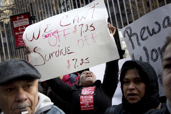 Protesters with signs hold a demonstration outside a Burger King restaurant in support of fast-food employees on strike in New York November 29, 2012. (Reuters/Andrew Kelly)