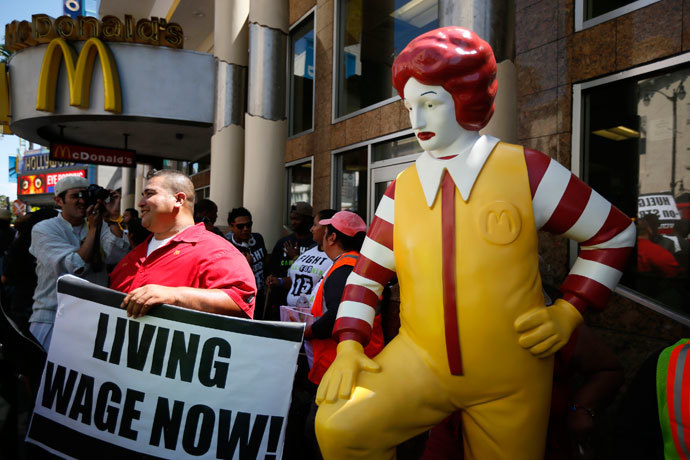 Striking McDonald's worker Bartolome Perez, 42, (L) protests outside McDonald's on Hollywood Boulevard as part of a nationwide strike by fast-food workers to call for wages of $15 an hour, in Los Angeles, California August 29, 2013.(Reuters / Lucy Nicholson)
