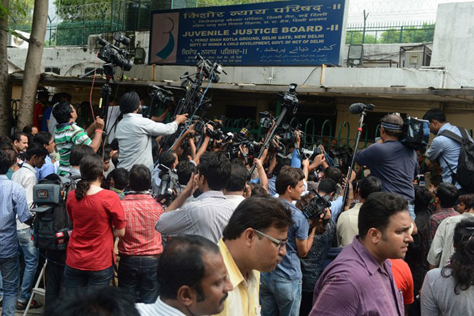 Indian international media cover the case of a juvenile, convicted in the December 2012 gang-rape of a student, in front of a juvenile court in New Delhi on August 31, 2013. (AFP Photo / Raveendran)