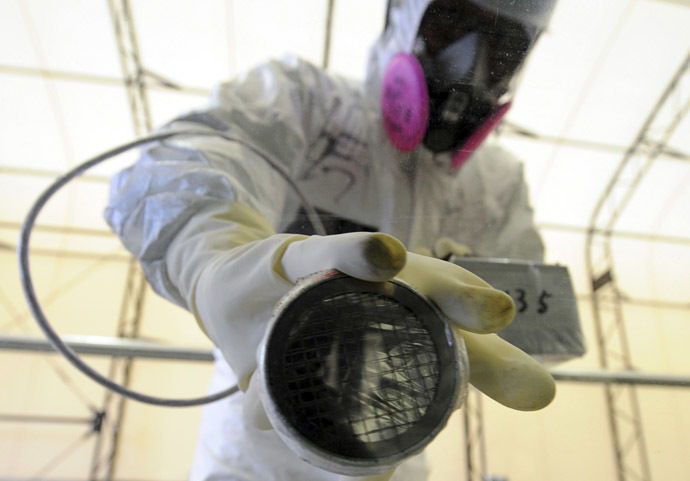 A worker takes radiation readings on the window of a bus at the screening point of the Tokyo Electric Power Company's (TEPCO) tsunami-crippled Fukushima Daiichi nuclear power plant in Fukushima prefecture (Reuters/Toshifumi Kitamura)