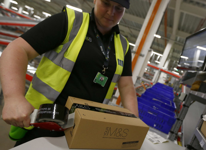 A worker boxes goods at the new Marks & Spencer e-commerce distribution center in Castle Donington, central England. (Reuters/Darren Staples)