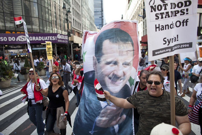 Demonstrators march after a rally on Times Square September 7, 2013 in New York City. (Ramin Talaie/Getty Images/AFP)