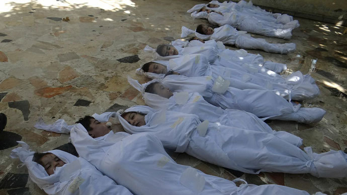 bodies of children wrapped in shrouds as Syrian rebels claim they were killed in a toxic gas attack by pro-government forces in eastern Ghouta, on the outskirts of Damascus on August 21, 2013.(AFP Photo / Shaam News Network)