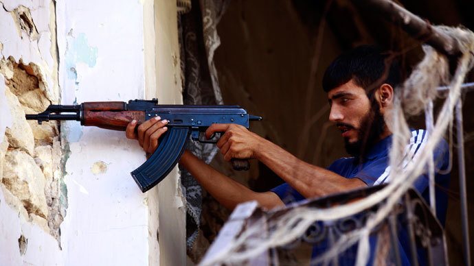 A Free Syrian Army fighter takes up a shooting position in Ogiwl, Aleppo, September 8, 2013.(Reuters / Hamid Khatib)