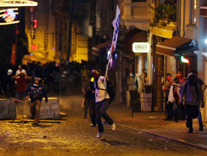 A demonstrator throws stones at riot police during a protest in central Istanbul September 10, 2013 (Reuters / Osman Orsal)