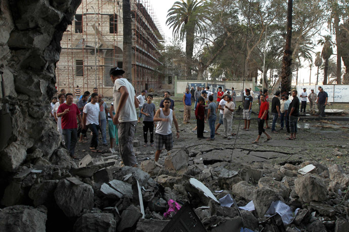 Libyans gather outside a foreign ministry building that was damaged by a powerful blast on September 11, 2013 in the eastern Libyan city of Benghazi. (AFP Photo/Abdullah Doma)