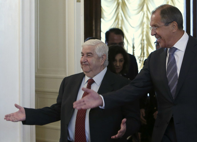 Russia's Foreign Minister Sergei Lavrov (R) shows the way to his Syrian counterpart Walid Moualem during a meeting in Moscow September 9, 2013. (Reuters/Sergei Karpukhin)