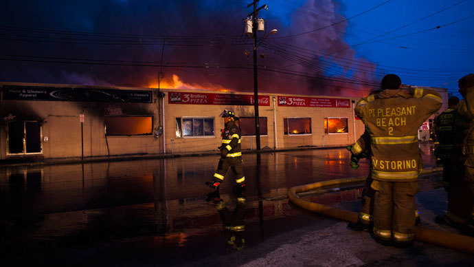 New Jersey firefighters walk near a massive fire as they work to control it in Seaside Park in New Jersey September 12, 2013.(Reuters / Eduardo Munoz)