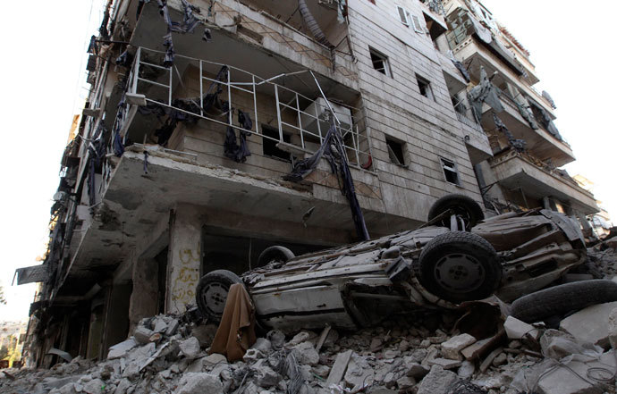 A damaged car is seen on the rubble of a damaged building in the Aleppo district of Salaheddine September 13, 2013.(Reuters / Muzaffar Salman)
