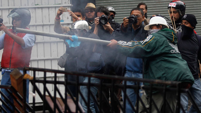 A protester holds an improvised weapon to shoot firecrackers at the riot police as striking members of the teachers' union CNTE are evicted from Zocalo Square in downtown Mexico City September 13, 2013.(Reuters / Edgard Garrido)