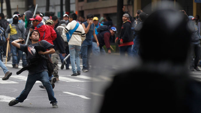 A protester throws stone as striking members of the teachers' union CNTE are evicted from Zocalo Square in downtown Mexico City September 13, 2013.(Reuters / Edgard Garrido)