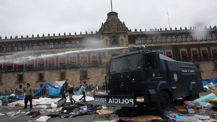 A federal police riot truck sprays water after striking members of the teachers' union CNTE are evicted from Zocalo Square in downtown Mexico City September 13, 2013.(Reuters / Tomas Bravo)