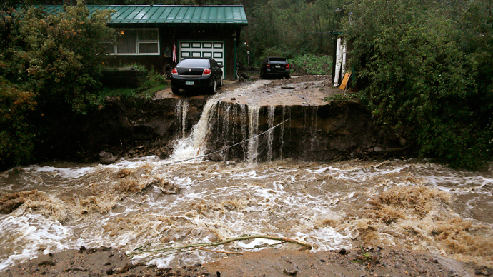 A home and car are stranded after a flash flood in Coal Creek destroyed the bridge near Golden, Colorado September 12, 2013 (Reuters / Rick Wilking)