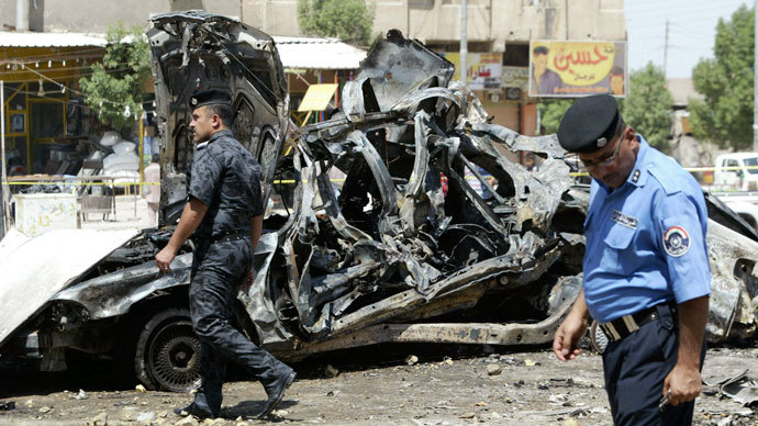 Iraqi security forces walk past damaged vehicles as they inspect the site of a car bomb attack in Basra, 420 km (261 miles) southeast of Baghdad, September 15, 2013. (Reuters / Essam Al-Sudani)