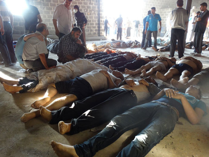 People inspecting bodies of children and adults laying on the ground as Syrian rebels claim they were killed in a toxic gas attack by pro-government forces in eastern Ghouta, on the outskirts of Damascus on August 21, 2013.(AFP Photo / Shaam News Network)