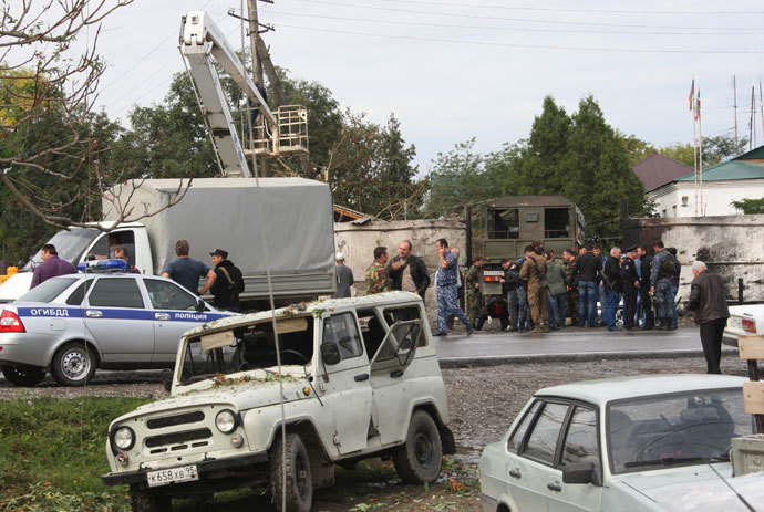 Police at the site of an explosion by the local police precinct in the village of Sernovodsk, Sunzhensky District, Chechen Republic. On September 16, three police officers were killed and four wounded in a suicide attack targeting the precinct.(RIA Novosti / Said Tcarnaev)