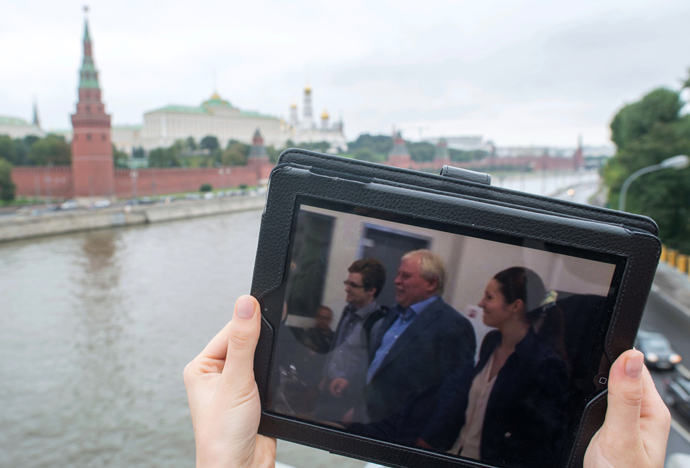 This tablet PC displays a photo of former CIA employee Edward Snowden and his lawyer Anatoly Kucherena leaving the Sheremetyevo airport. Snowden remained in the airport's transit area for over a month and was granted provisional asylum in Russia for one year (RIA Novosti / Iliya Pitalev)