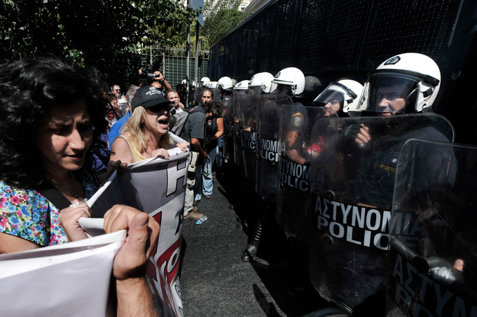 Public sector employess shout to police blocking their way to the Greek Parliament in Athens on September 18, 2013 during a 48-hours civil servants strike (AFP Photo / Louisa Gouliamaki)