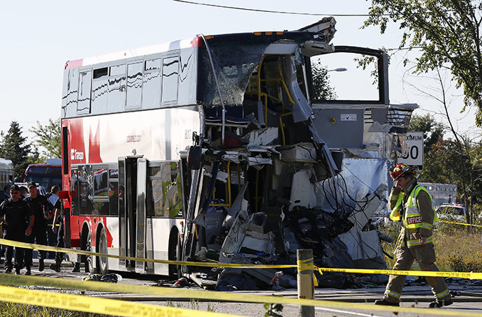 A firefighter walks in front of the scene of an accident involving a bus and a train in Ottawa September 18, 2013. (Reuters / Chris Wattie)