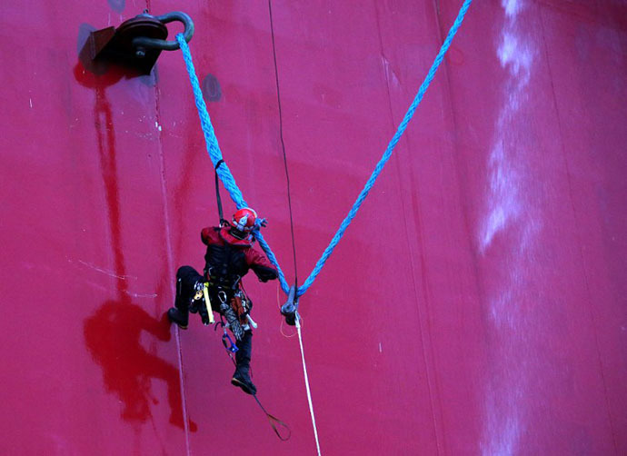 A handout photo taken by Greenpeace on September 18, 2013, shows a Greenpeace activist attempting to climb Gazprom's 'Prirazlomnaya' Arctic oil platform somewhere off Russia north-eastern coast in the Pechora Sea. (AFP Photo / Greenpeace / Denis Sinyakov)