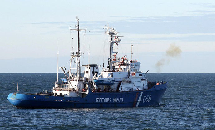 A Russian Coast Guard ship firing a warning shot to stop the Arctic Sunrise Greenpeace icebreaker during an environmentalists' attempt to climb Gazprom's 'Prirazlomnaya' Arctic oil platform on September 18, 2013. (AFP Photo / Greenpeace / Denis Sinyakov)