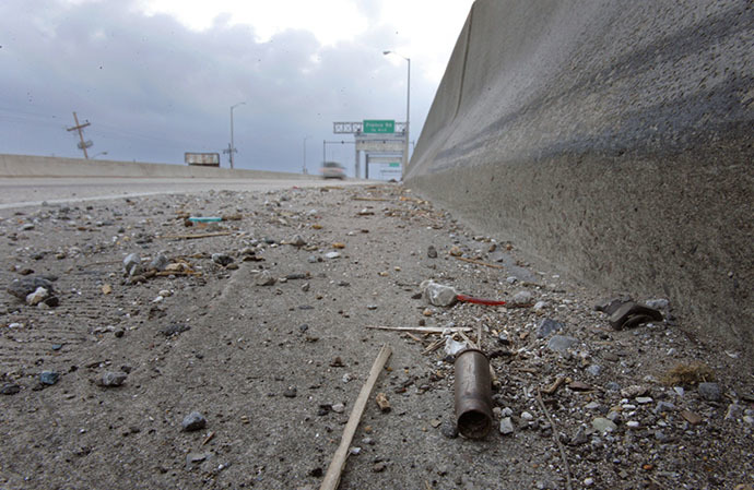 A spent shell casing lies alongside the road on Danziger Bridge in eastern New Orleans, Louisiana November 10, 2005. (Reuters / Lucas Jackson)