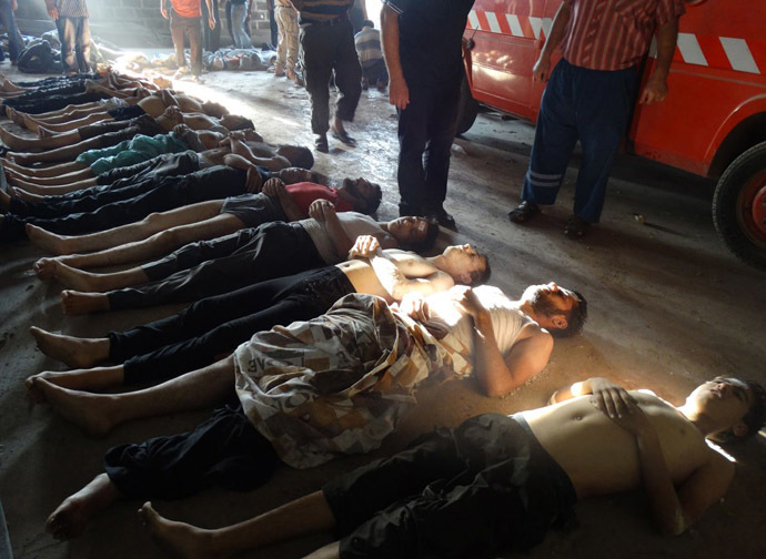 A handout image released by the Syrian opposition's Shaam News Network shows bodies of boys and men lined up on the ground in the eastern Ghouta suburb of Damascus, whom the Syrian opposition said on August 21, 2013 were killed in a toxic gas attack by pro-government forces. (AFP Photo/Shaam News Network)
