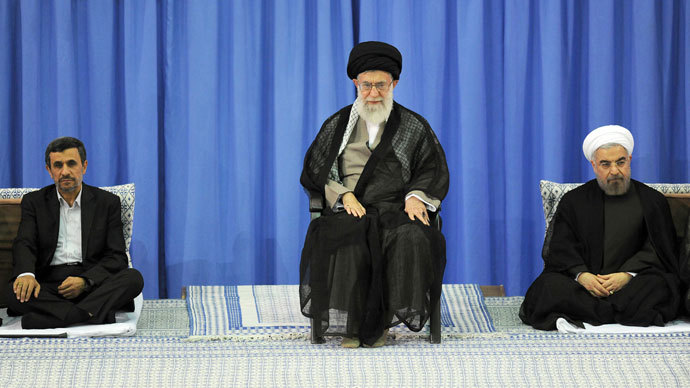 A handout picture released by the official website of the Iranian supreme leader Ayatollah Ali Khamenei on August 3, 2013, shows Khamenei (C) during a ceremony officially endorsing moderate cleric Hassan Rowhani (R) in the capital Tehran, as former president Mahmoud Ahmadinejad (L).(AFP Photo / Khamenei.Ir)