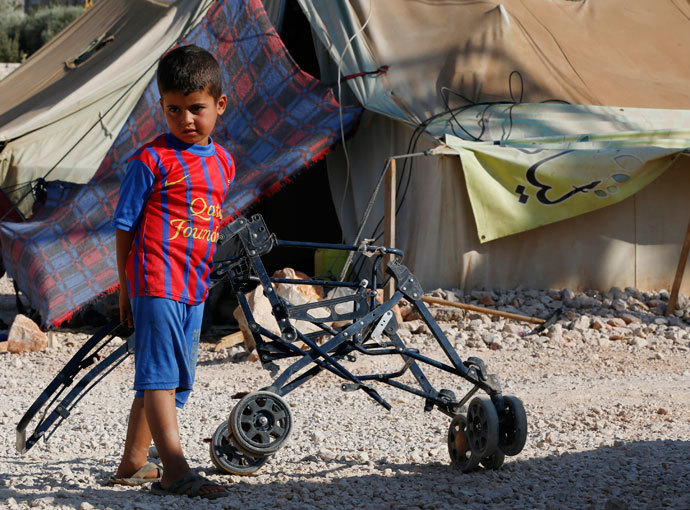 A Syrian refugee child who arrived with his family from Damascus, plays at the Majdal Anjar refugee camp in Bekaa Valley near the Syrian border in eastern Lebanon.(Reuters / Jamal Saidi)