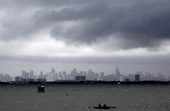 Fishermen ride on their boat as dark clouds loom over the city brought by Super Typhoon Usagi in Navotas City, metro Manila September 21, 2013. (Reuters / Romeo Ranoco)