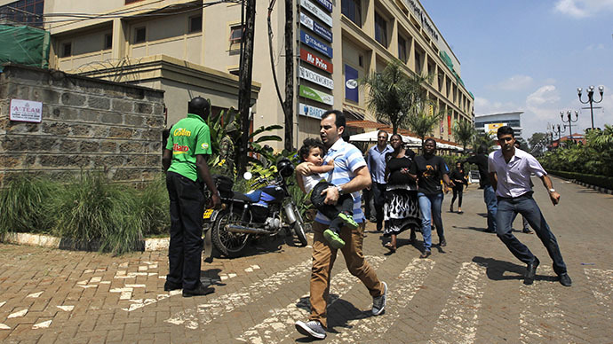 Customers run following a shootout between unidentified armed men and the police at the Westgate shopping mall in Nairobi September 21, 2013. (Reuters / Thomas Mukoya)