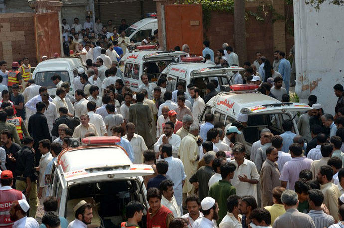 Ambulances are parked outside the Church after two suicide bomb attacks in Peshawar on September 22, 2013. (AFP Photo / A. Majeed)