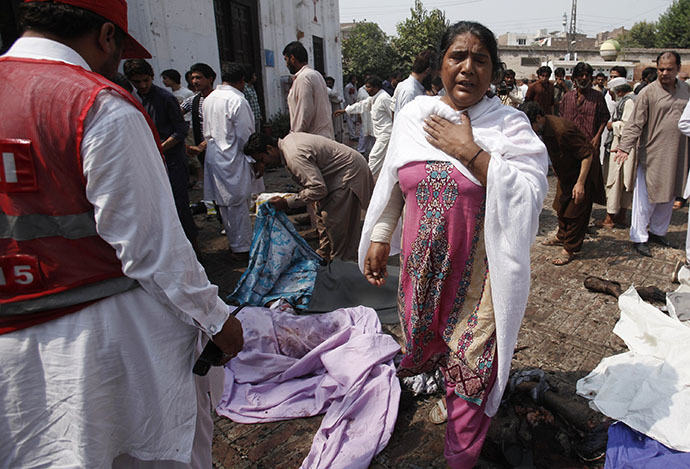 A woman mourns the death of her relatives at the site of a suicide blast at a church in Peshawar September 22, 2013. (Reuters / Fayaz Aziz)